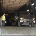 Airmen load refueling trucks onto aircraft