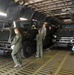 Airmen load refueling trucks onto aircraft