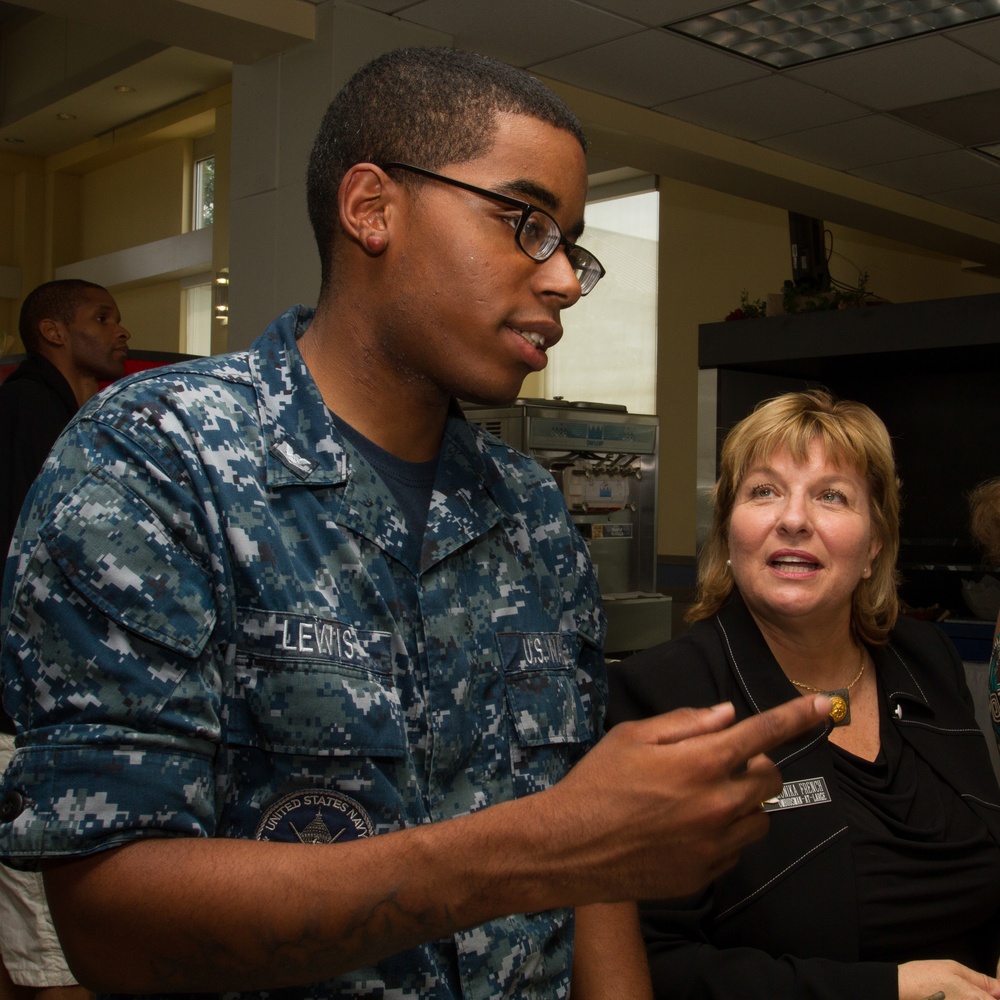 Yeoman Third Class Kerri Lewis of Navy's Ceremonial Guard describes his duties and life aboard the Joint Base Anacostia-Bolling with Chief of Naval Operations' Ombudsman-at-Large Monika French