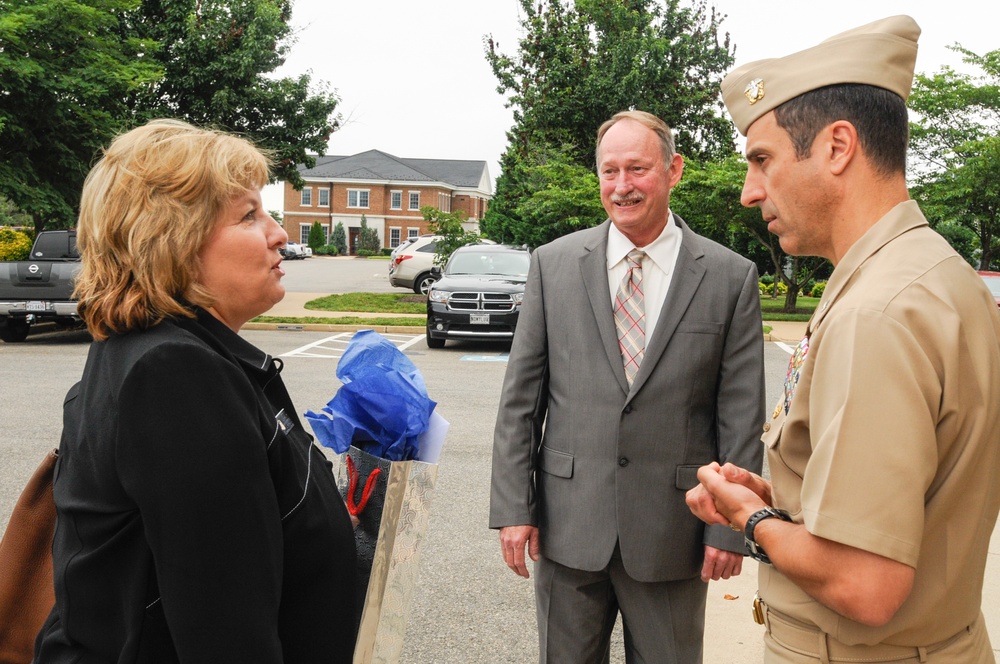 Chief of Naval Operations Ombudsman-at-Large Monika French is greeted by Joint Base Anacostia-Bolling Commander Navy Capt. Anthony T. Calandra and Stuart Marshall for a day of informational meetings and visit with base ombudsman