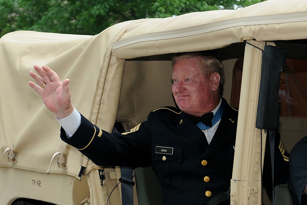 Medal of Honor recipient waves to the crowd at Independence Day parade