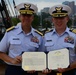 Coast Guard commander promoted to captain on Navy Ship