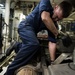 USS Freedom sailor works on diesel engine