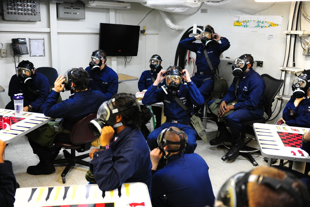 Sailors put on gas masks