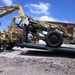 Two Army transport trucks unload cannons in Harrodsburg, Ky. for an August tribute honoring fallen Veterans