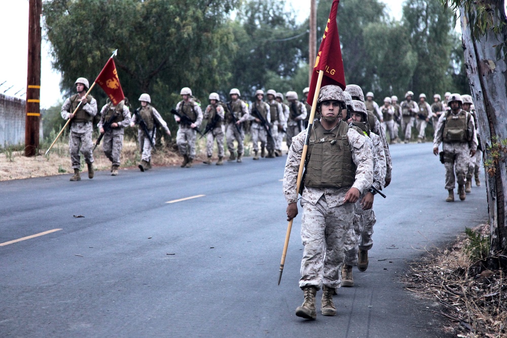 Marines shoulder packs, conduct regimental hike