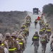 Marines shoulder packs, conduct regimental hike