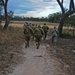 A group of US and Australian soldiers escort Australian Army Major General to an airfield