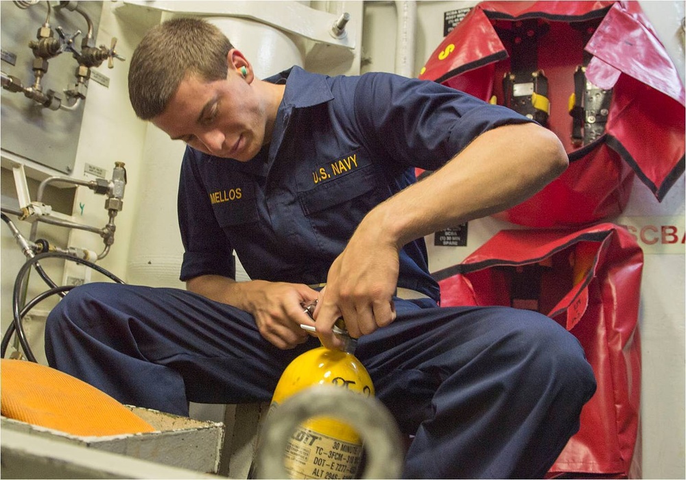 Midshipman practices refilling oxygen tank