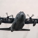 C-130 takes off with propeller vortices