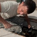 Airmen feed cable under flightline for new tower