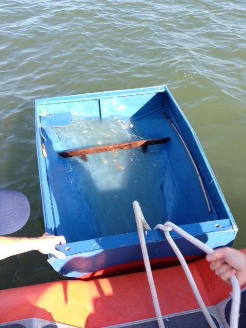 Small homemade fishing craft partially submerged
