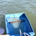 Small homemade fishing craft partially submerged