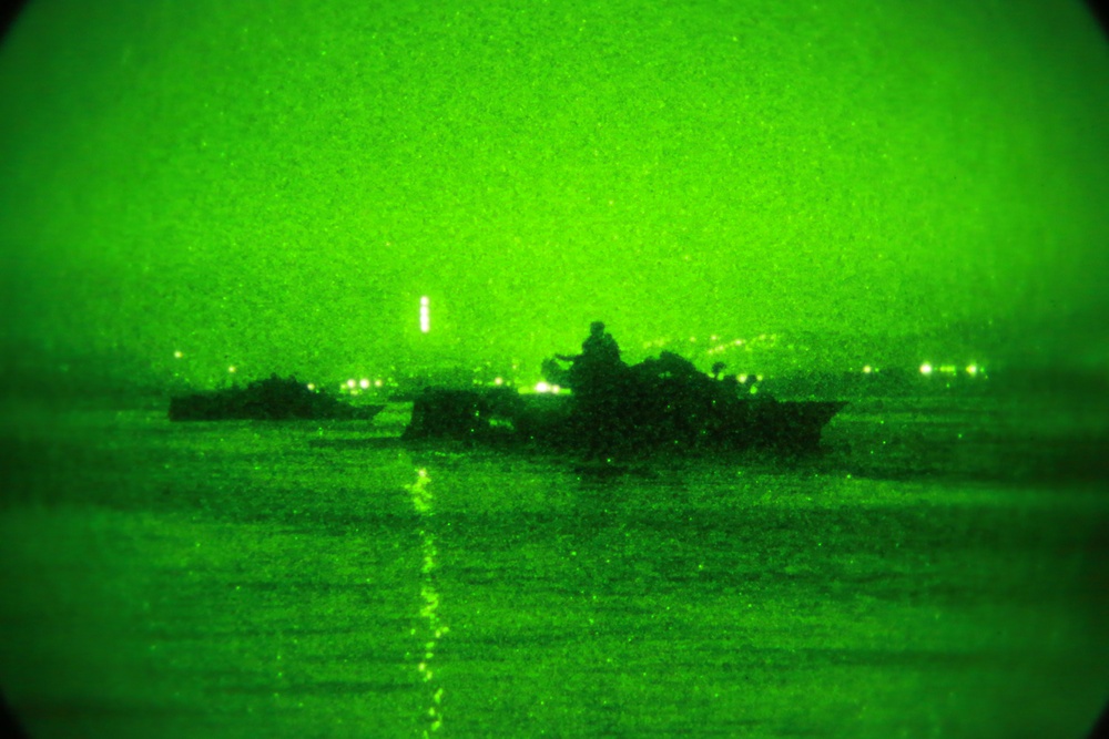 Amphibious assault vehicles perform nighttime assault