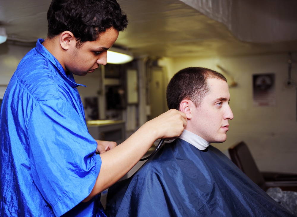 USS George H.W. Bush gets hair cut in barber shop