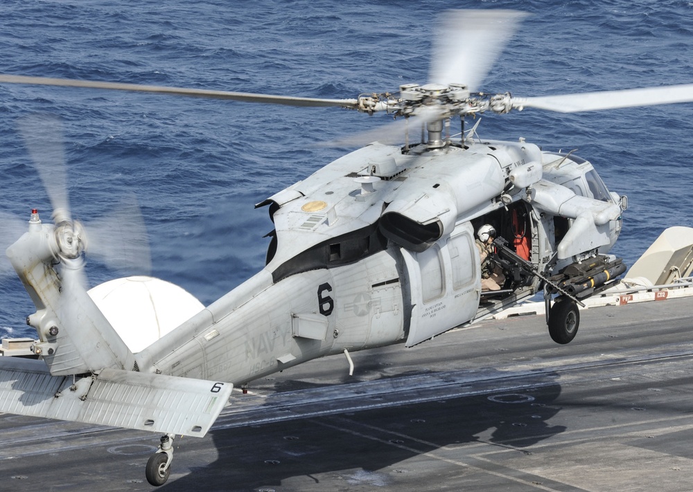 Helicopter takes off from USS Nimitz