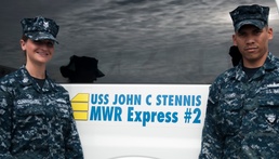 USS Stennis sailors help cyclist