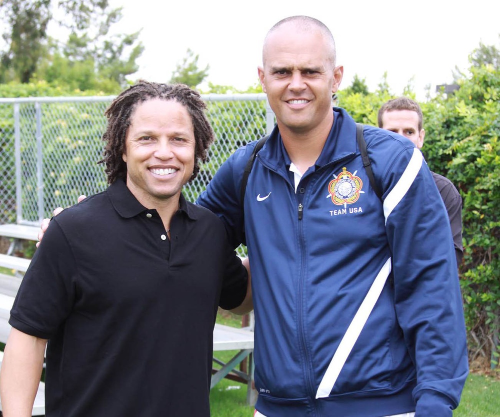 Capt. Roye Locklear of the Florida Army National Guard (right) poses with soccer star Cobi Jones