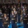 Lt. Gen. Dana Kyle Chipman retirement ceremony A formal U.S. Army military ceremony featuring multiple rows of uniformed soldiers standing at attention in dress uniforms. The personnel display numerous medals, ribbons, and insignia, with at least one soldier carrying a unit guidon or ceremonial flag. The setting appears to be an indoor venue with a polished floor, suggesting an official parade or change-of-command ceremony.