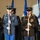 Lt. Gen. Dana Kyle Chipman retirement ceremony A formal military honor guard ceremony featuring U.S. Army soldiers in dress uniforms standing at attention with ceremonial rifles. The soldiers are arranged in formation, wearing distinctive dress blues and blacks with gold trim, medals, and white gloves. Flags are visible in the background, indicating an official ceremonial event.