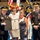 Lt. Gen. Dana Kyle Chipman retirement ceremony A formal military ceremony in which two U.S. Army generals in dress uniforms present a Certificate of Appreciation to two civilian women. The certificate bears the Great Seal of the United States and is issued by the United States Army. The event takes place in a large ceremonial hall with color guard soldiers and military flags visible in the background.