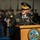 Lt. Gen. Dana Kyle Chipman retirement ceremony A senior U.S. Army officer with the name tag 'DEMPSEY' is delivering a speech at a podium bearing the official seal of the Department of the Army. The officer wears a dress uniform with four-star rank insignia, a heavily decorated service ribbon rack, and a peaked cap with gold braid. A formation of uniformed soldiers is visible in the blurred background.