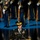 Lt. Gen. Dana Kyle Chipman retirement ceremony A U.S. Army general officer identified by nameplate as 'DEMPSEY' stands at a wooden podium bearing the official seal of the Department of the Army, United States of America (est. 1775). The officer is wearing a dress uniform with a general officer's cap featuring gold oak leaf scrambled eggs, multiple service ribbons, and shoulder insignia. In the background, a military honor guard in dress uniforms stands at attention on a raised blue-carpeted platform.