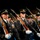Lt. Gen. Dana Kyle Chipman retirement ceremony A formation of U.S. Army soldiers in dress uniform are marching in a ceremonial parade or drill performance. They are carrying rifles at a uniform angle and wearing matching formal attire with medals, white gloves, and service caps. The disciplined formation and identical positioning suggest a highly rehearsed honor guard or ceremonial unit performance.