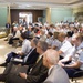 Rear Adm. Frederick J. Kenney speaks to a full crowd at the Armed Forces Retirement Home during a Coast Guard birthday celebration in Washington, DC