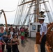 USCGC Eagle crew members talk with tourists