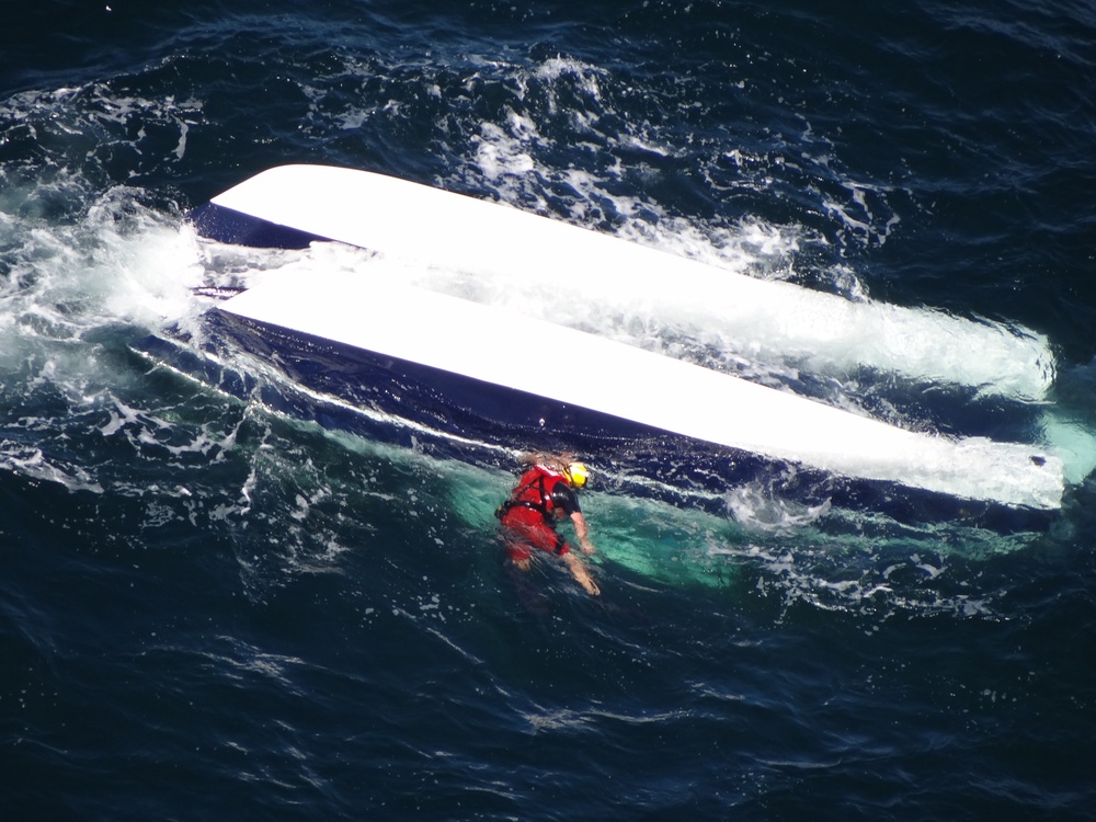 Coast Guard rescue swimmer searching for missing boaters