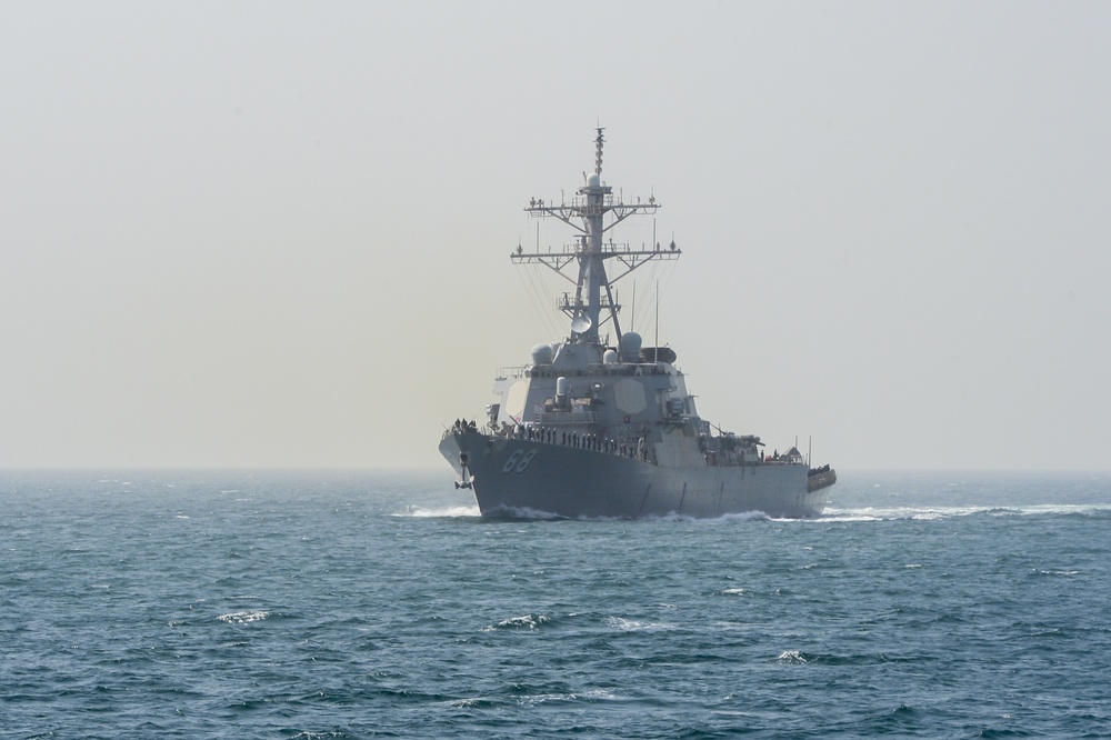 USS The Sullivans passes USS Monterey