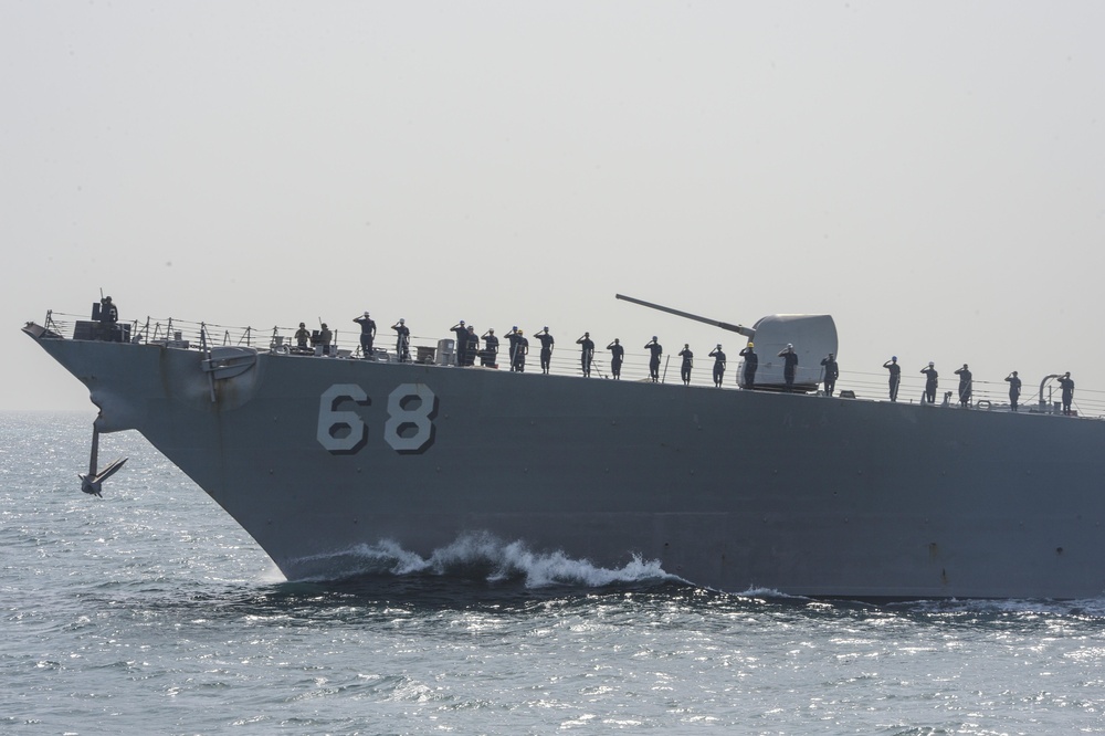 USS The Sullivans renders passing honors to USS Monterey