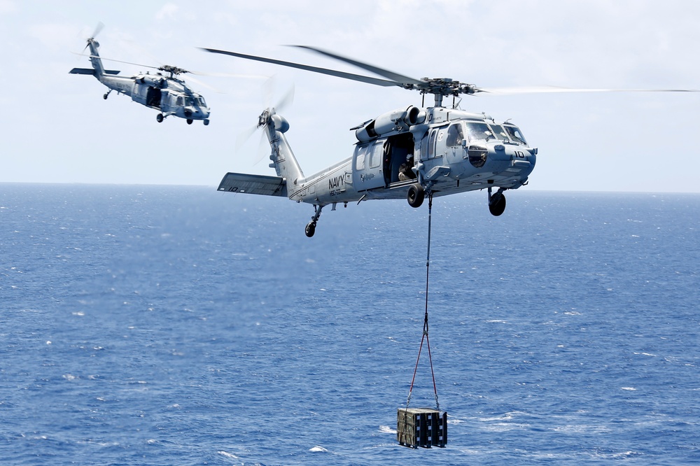 MH-60S Sea Hawk helicopters approach USS Harry S. Truman