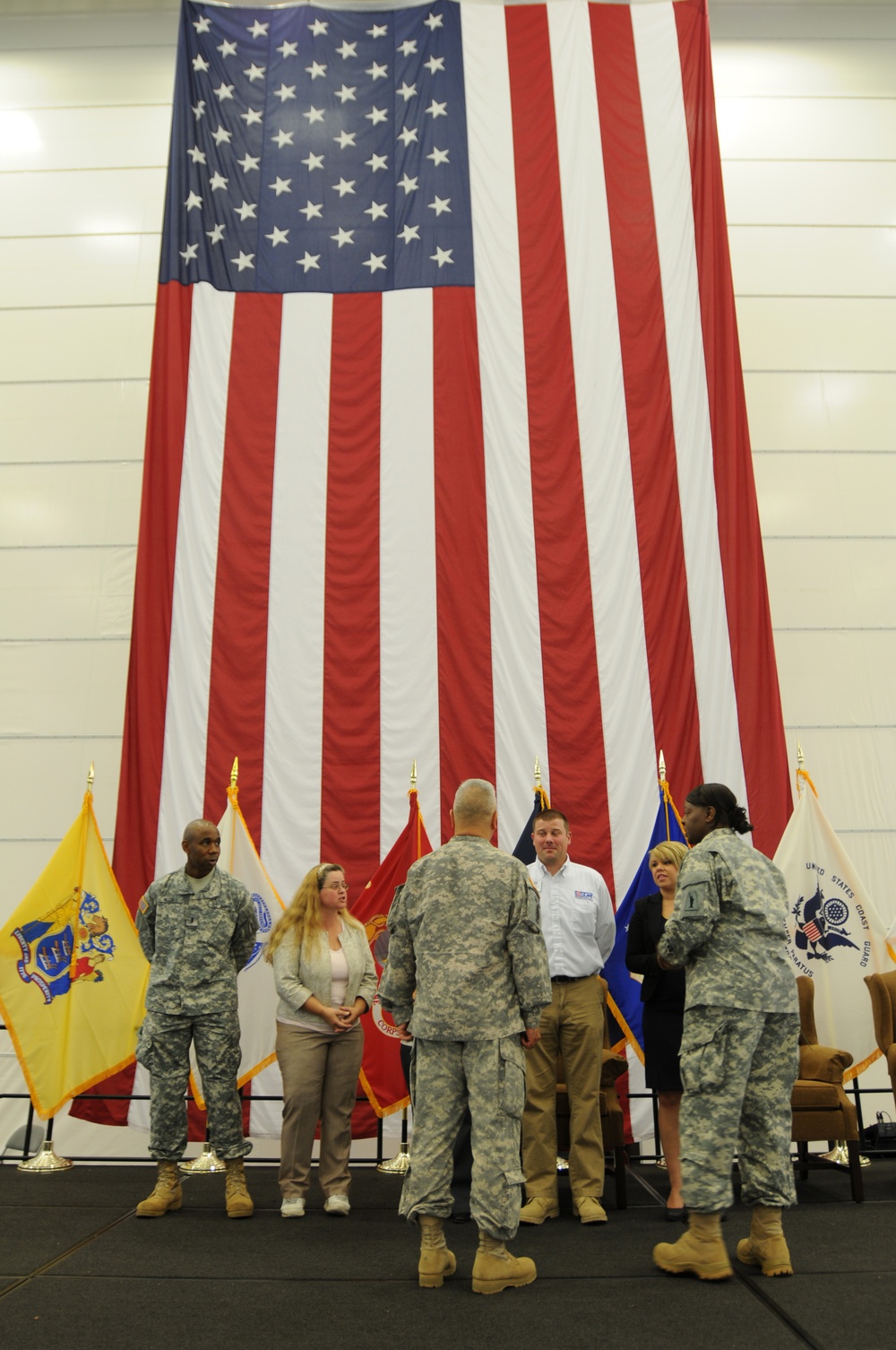 U.S. Army Col. Joyce Junior, Commander of the 77th Sustainment Brigade and Command Sergant Major Sammy Sablan of the 77th SB speak with career expo coordinators