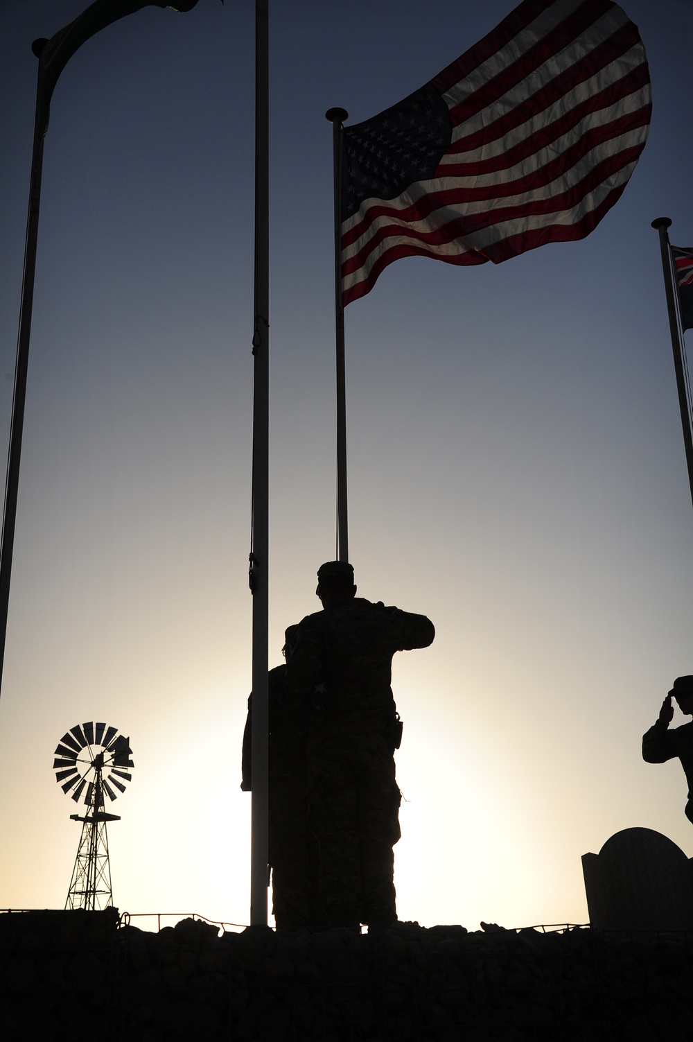 Soldiers raise American flag at coalition base