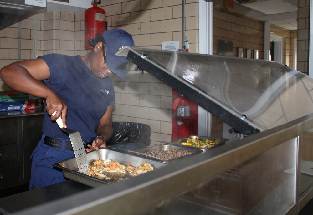 The noon meal is being served on the mess deck