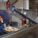 The noon meal is being served on the mess deck