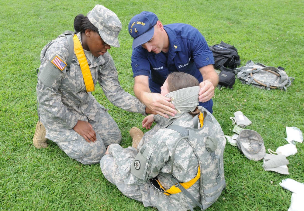 US Coast Guard Chief Petty Officer Bartonlini demonstrates proper use of bandages to soldiers at OSW