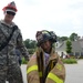 Firefighter exchanges hats with a family member during National Night Out Safety Fair