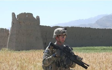 Army engineer searches on open field for IEDs in eastern Afghanistan