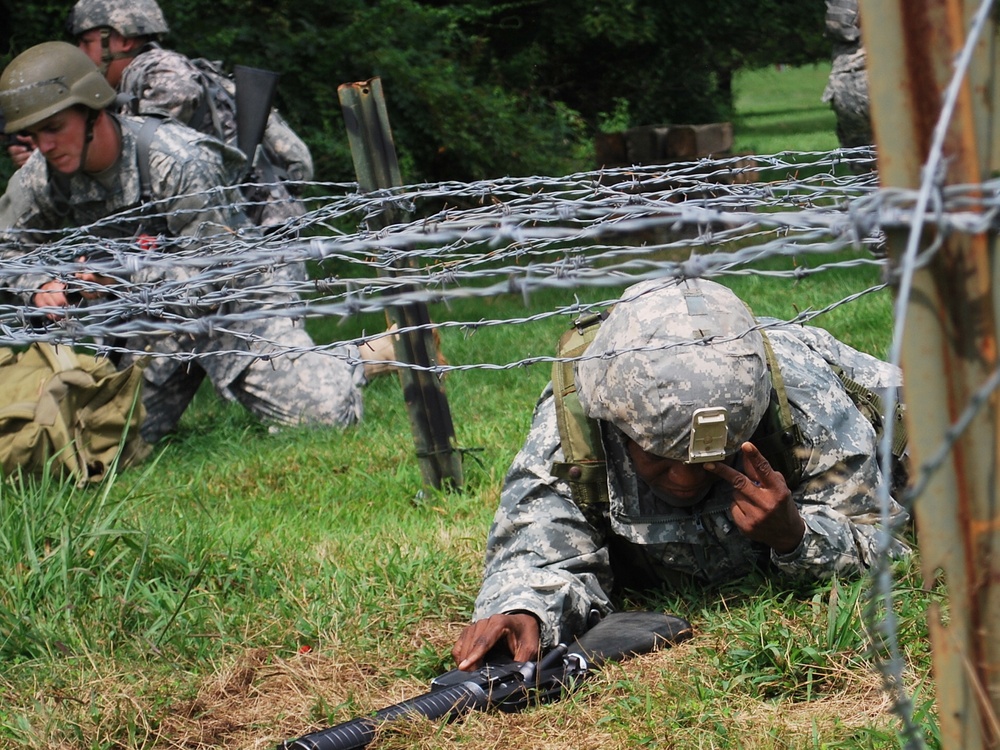 OSW soldier low crawls under barbed wire