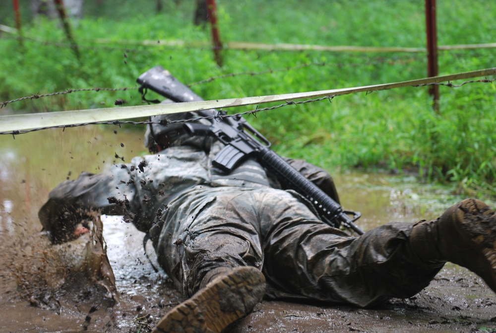 OSW soldier low crawls under barbed wire and through mud