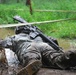 OSW soldier low crawls under barbed wire and through mud