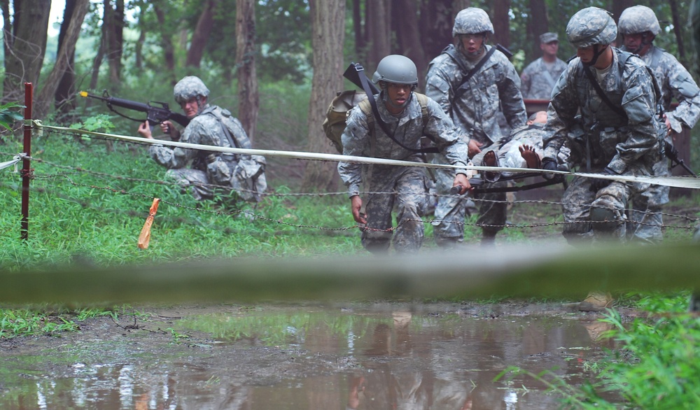 OSW soldiers carry a litter towards obstacle