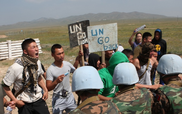 MAF Soldiers quell a riot during exercise Khaan Quest 2013
