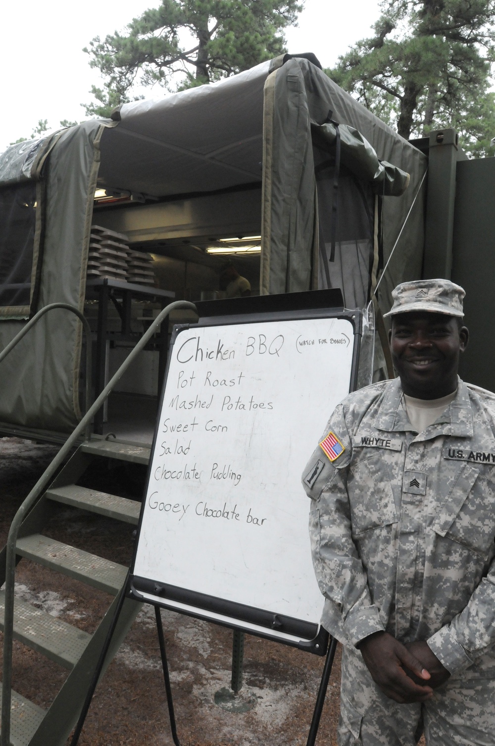 OSW Sgt. Whyte stands in front of mobile dining facility