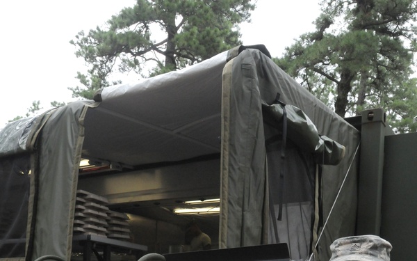 OSW Sgt. Whyte stands in front of mobile dining facility