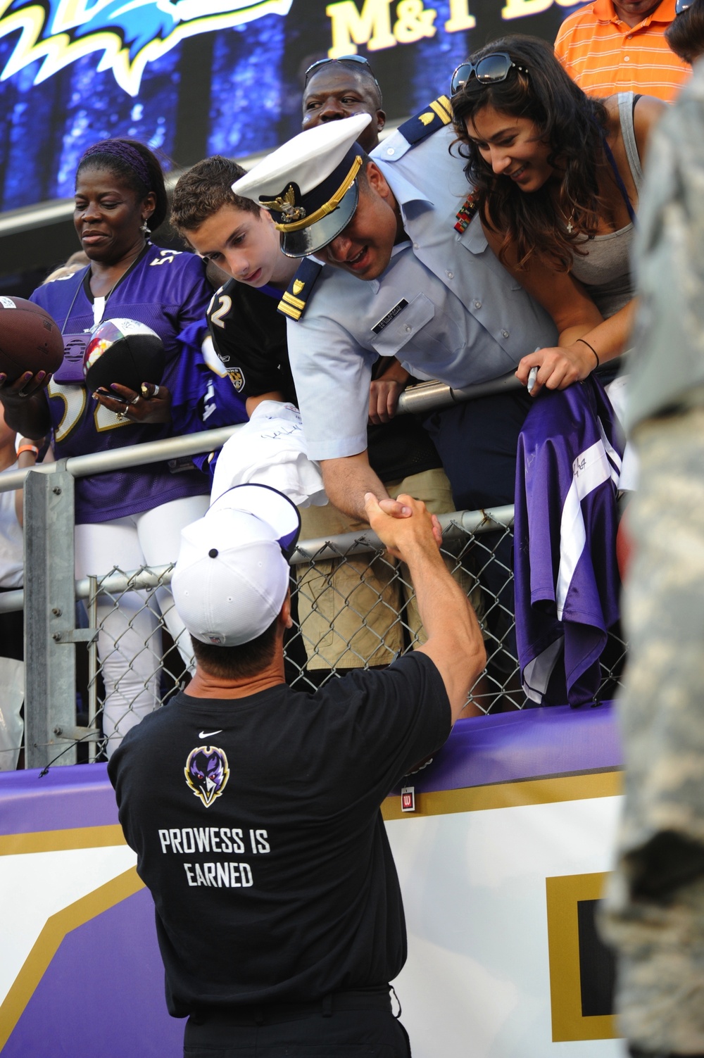 Coach Harbaugh thanks Coast Guardsman Lt. Vasilarakis