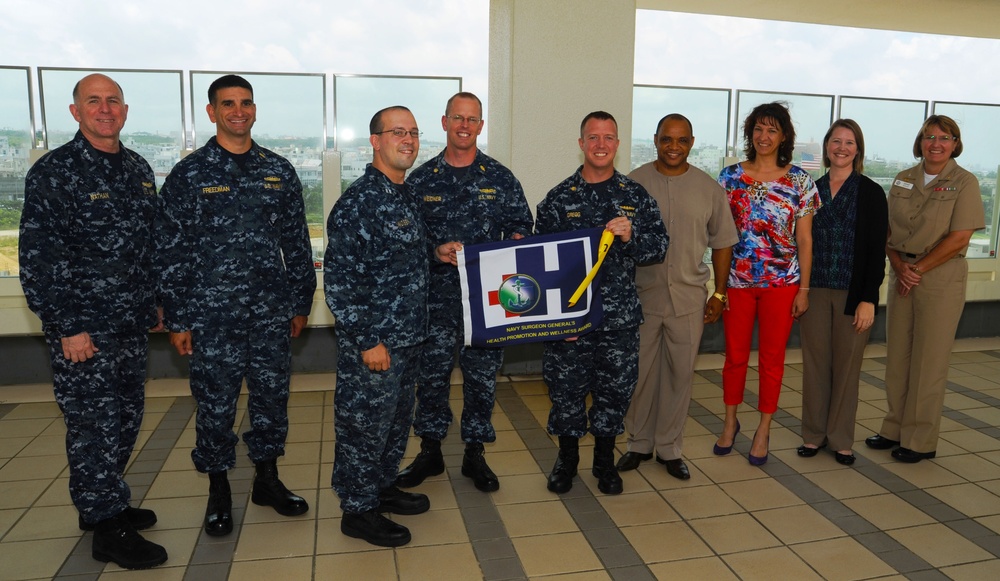 Surgeon general presents Blue 'H' flag to USNH Okinawa Health Promotion staff